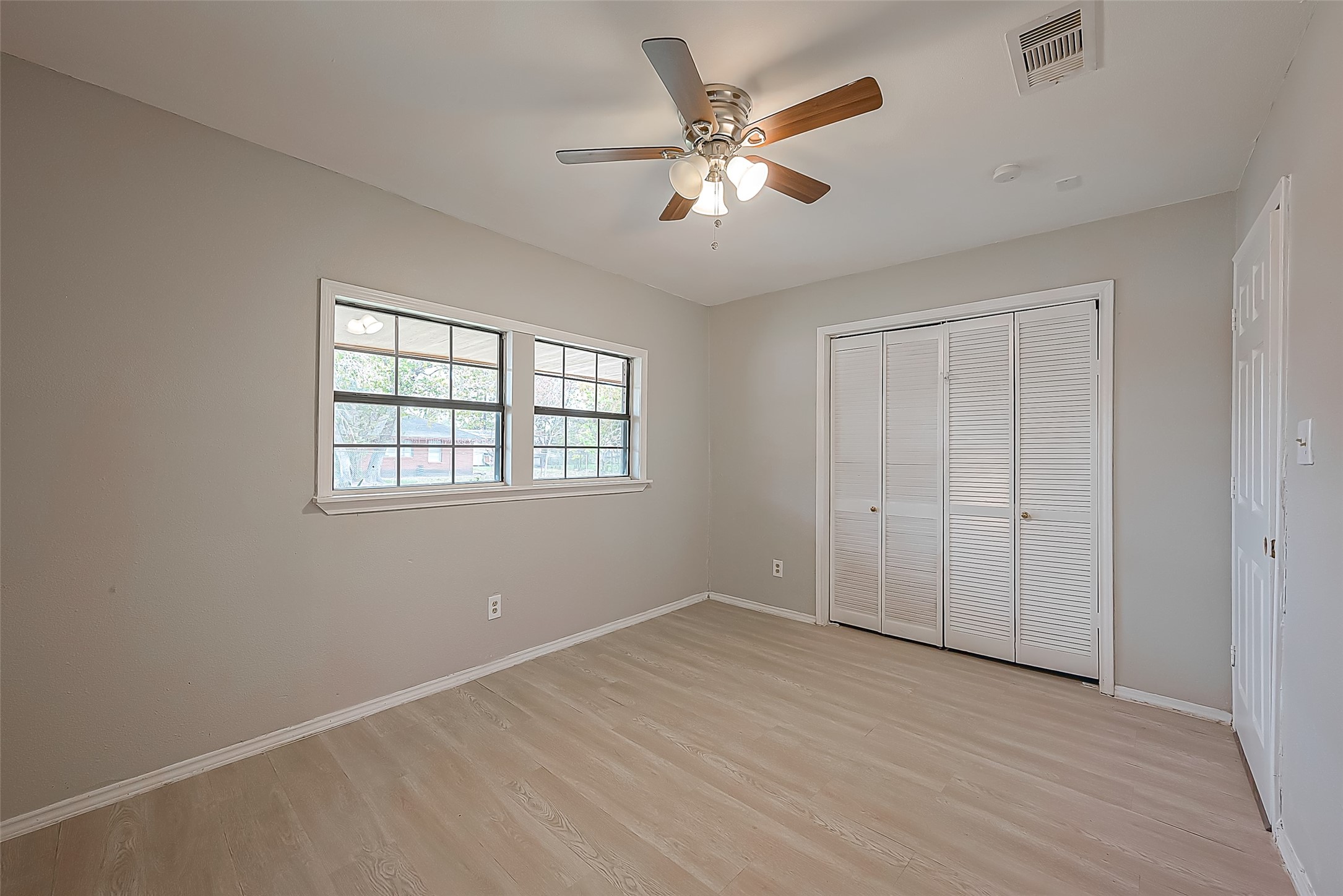 11615 Duane Street Houston, TX 77047 - Photo 5 of 14 wooden floor in an empty room with a window