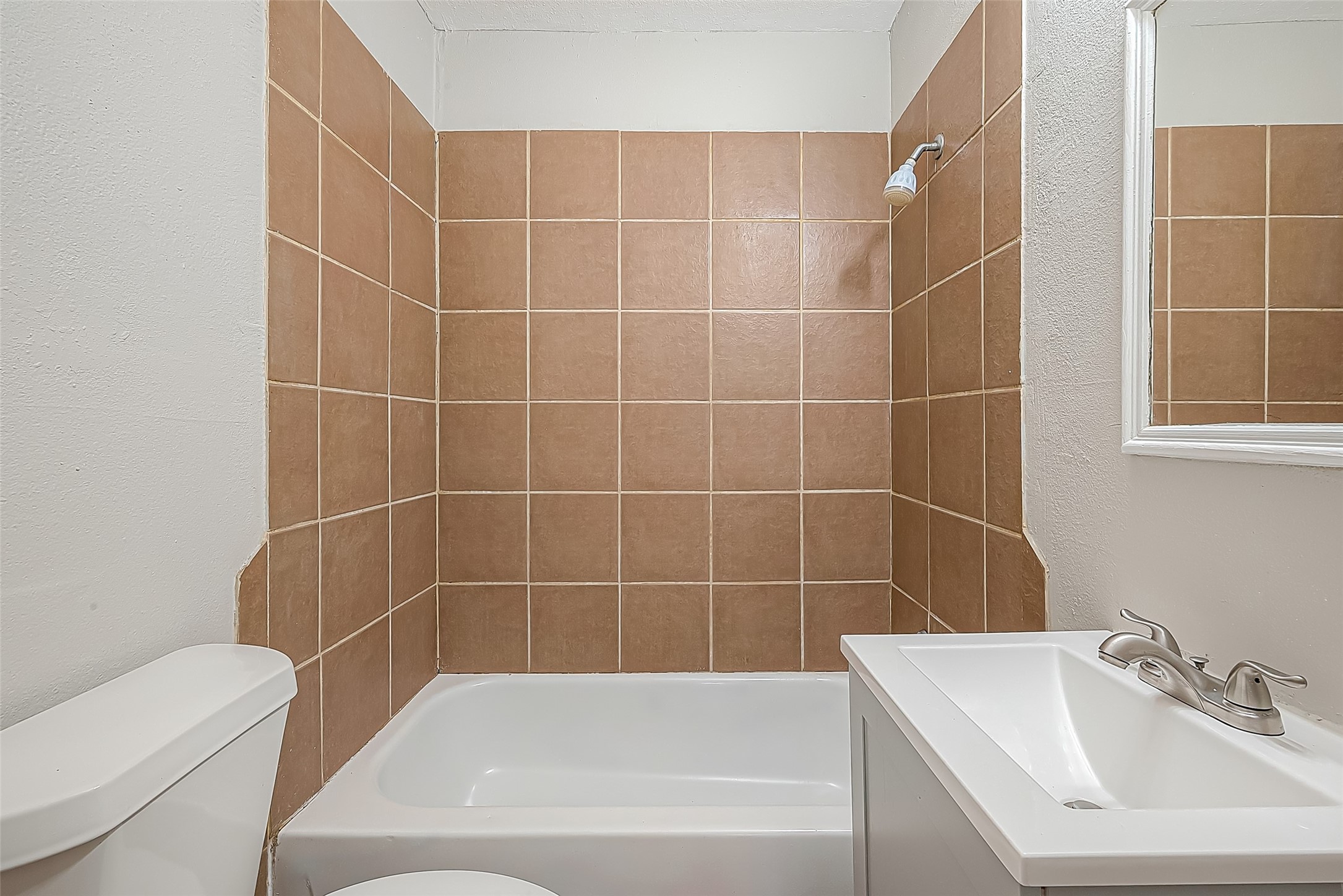 11615 Duane Street Houston, TX 77047 - Photo 6 of 14 a white bath tub sitting next to a white sink