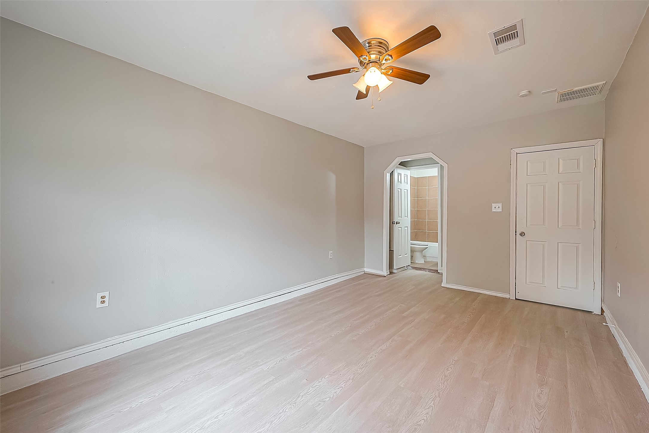 11615 Duane Street Houston, TX 77047 - Photo 7 of 14 an empty room with wooden floor and ceiling fan