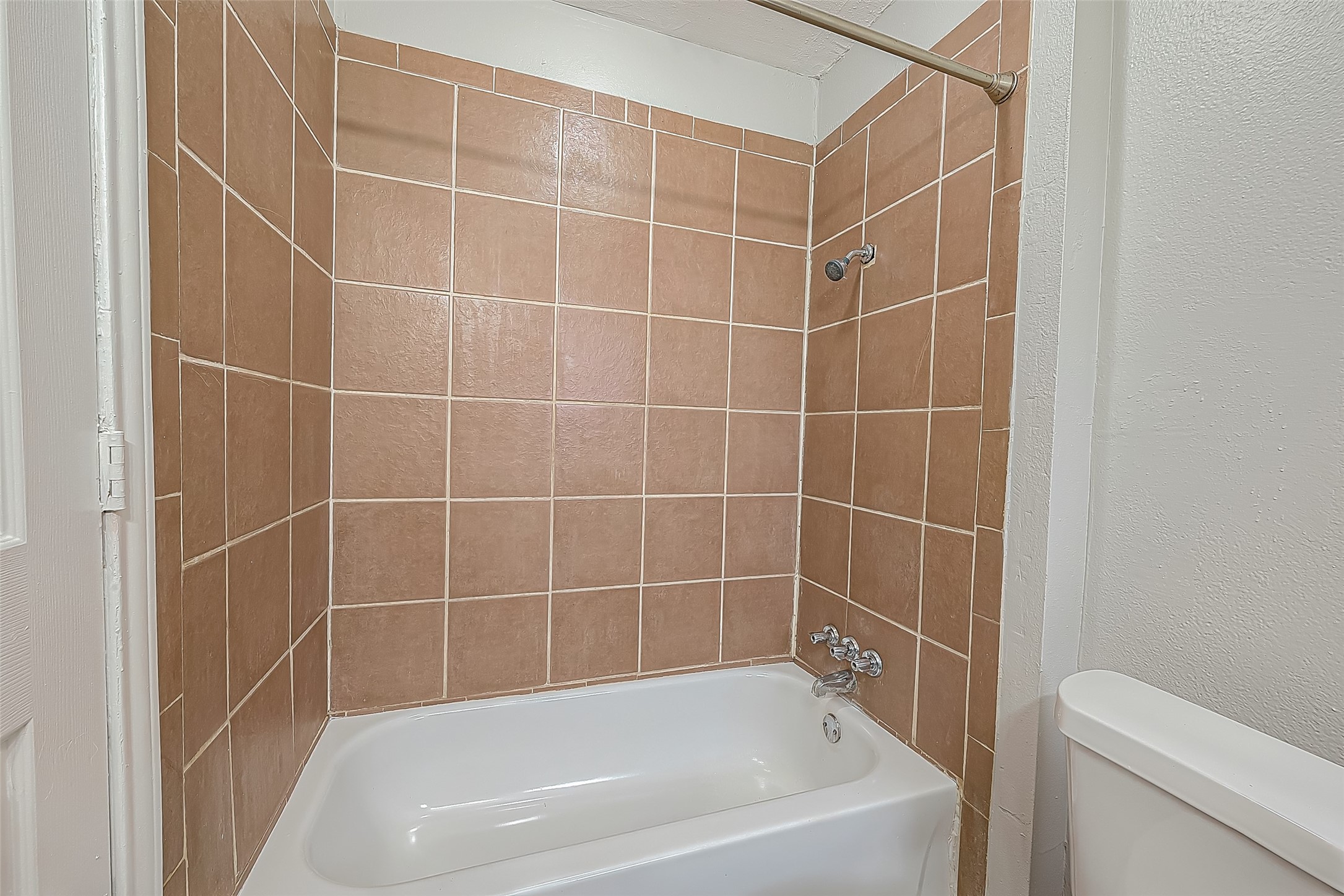 11615 Duane Street Houston, TX 77047 - Photo 9 of 14 a white bath tub and a shower