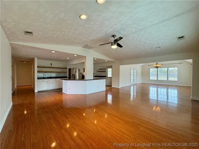 a view of kitchen and hall with wooden floor