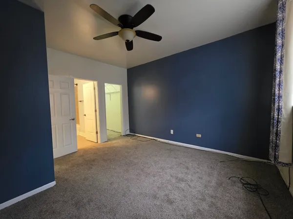 an empty room with a empty space and a ceiling fan