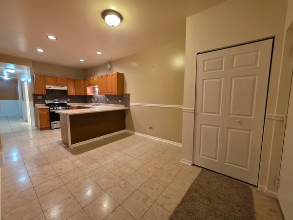a view of kitchen appliances and cabinets