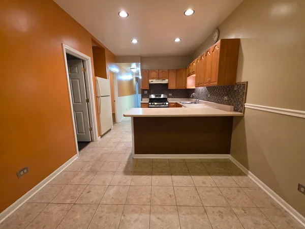 a view of kitchen with stainless steel appliances granite countertop a sink and a stove