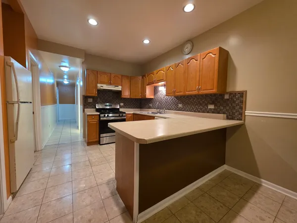 a kitchen with a sink appliances and cabinets