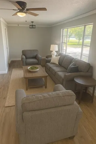 a living room with furniture and a large window