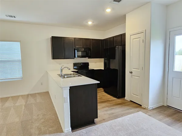 a kitchen with kitchen island a sink stainless steel appliances and cabinets