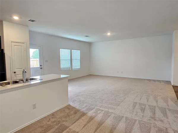 a view of a kitchen with a sink and window