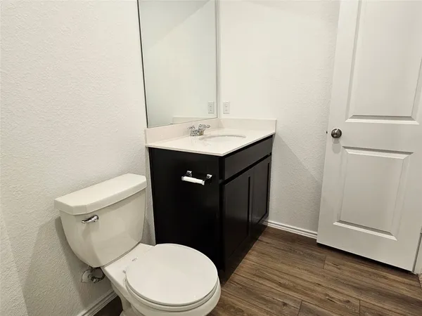 a bathroom with a sink toilet and vanity