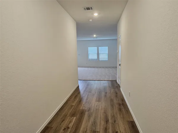 a view of wooden floor in a hallway