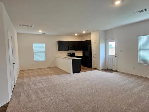a view of a kitchen with a sink and a fireplace