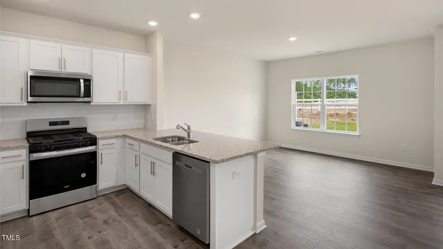 a kitchen with granite countertop a sink and a stove top oven