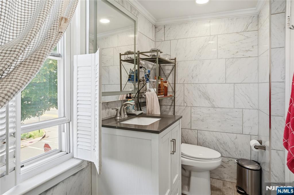 33-35 Pulaski Place Hackensack, NJ 07601 - Photo 13 of 32 a bathroom with a sink a toilet and a shower