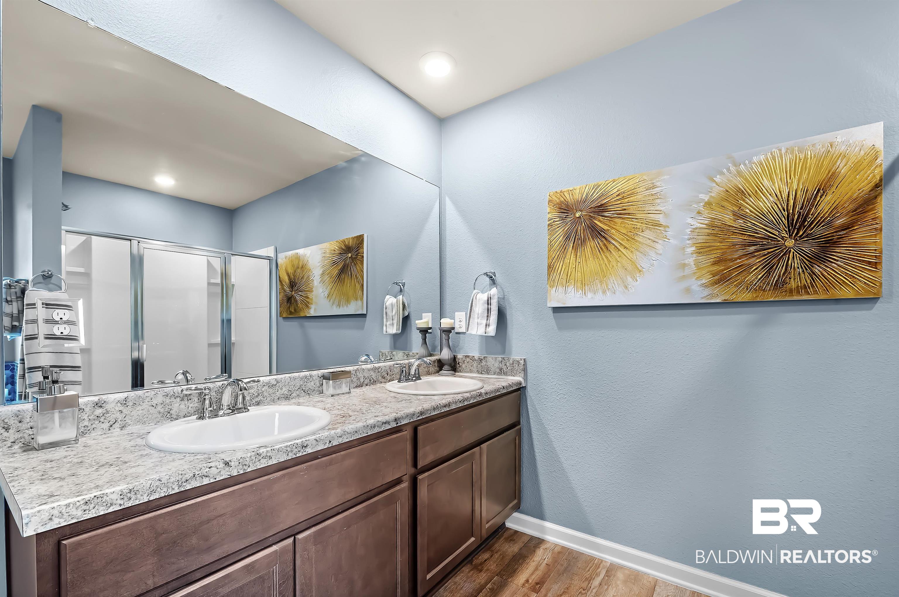 17985 Lewis Smith Drive Foley, AL 36535 - Photo 28 of 56 Bathroom featuring hardwood / wood-style floors, an enclosed shower, and vanity