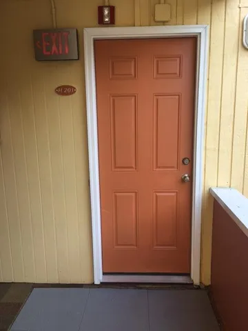a view of a small space with wooden floor and a window