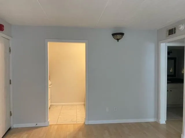 a kitchen with granite countertop white cabinets and a sink