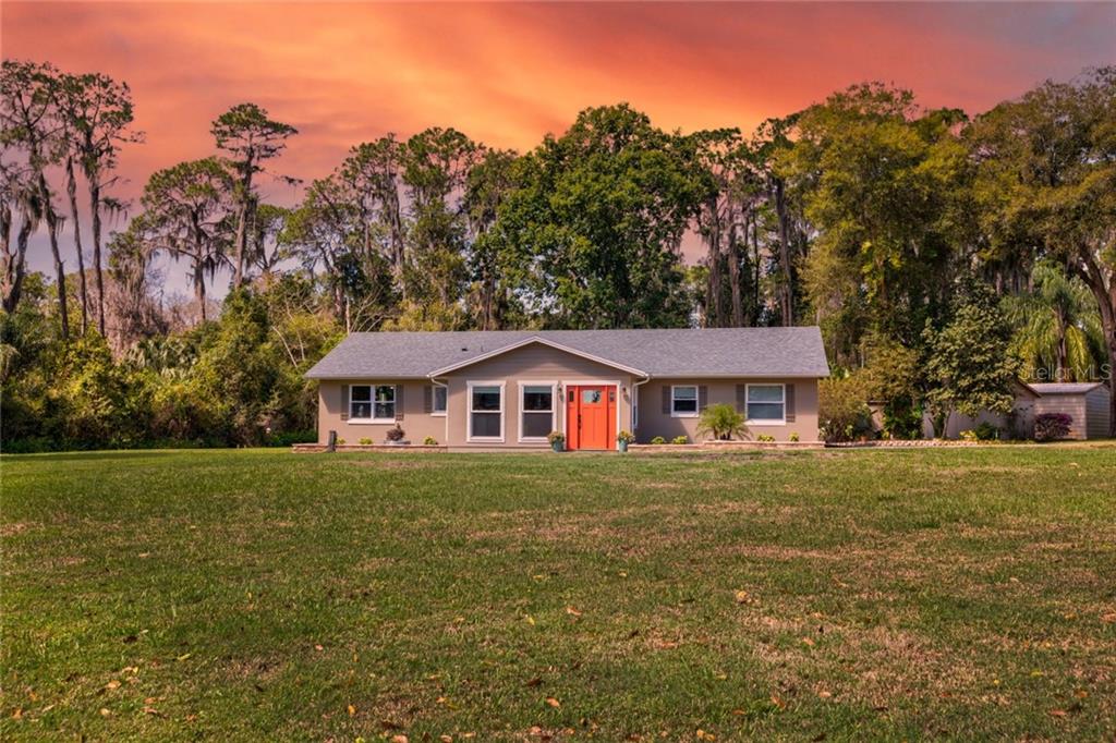 895 Shore Acres Road Mount Dora, FL 32757 - Photo 1 of 1 a front view of a house with a garden