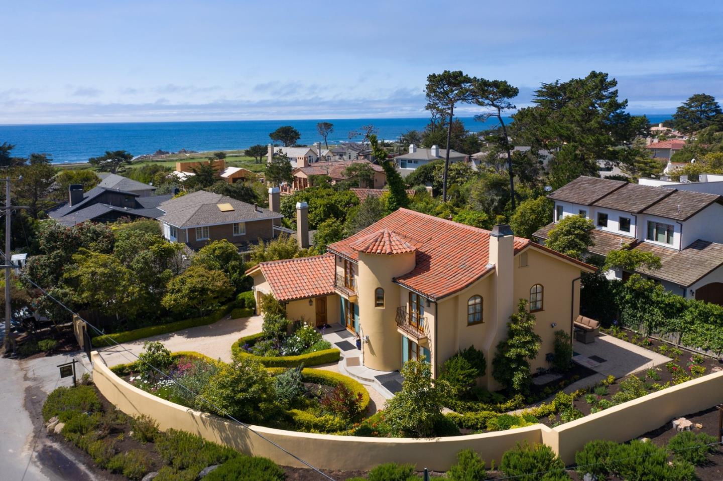 1007 Ocean Road Pebble Beach, CA 93953 - Photo 1 of 24 a aerial view of a house with a garden and lake view