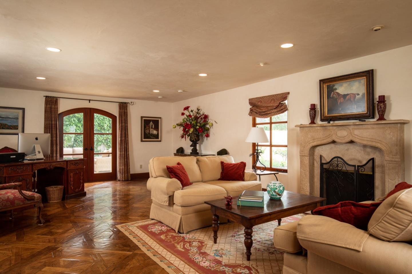 1007 Ocean Road Pebble Beach, CA 93953 - Photo 11 of 24 a living room with furniture fireplace and window