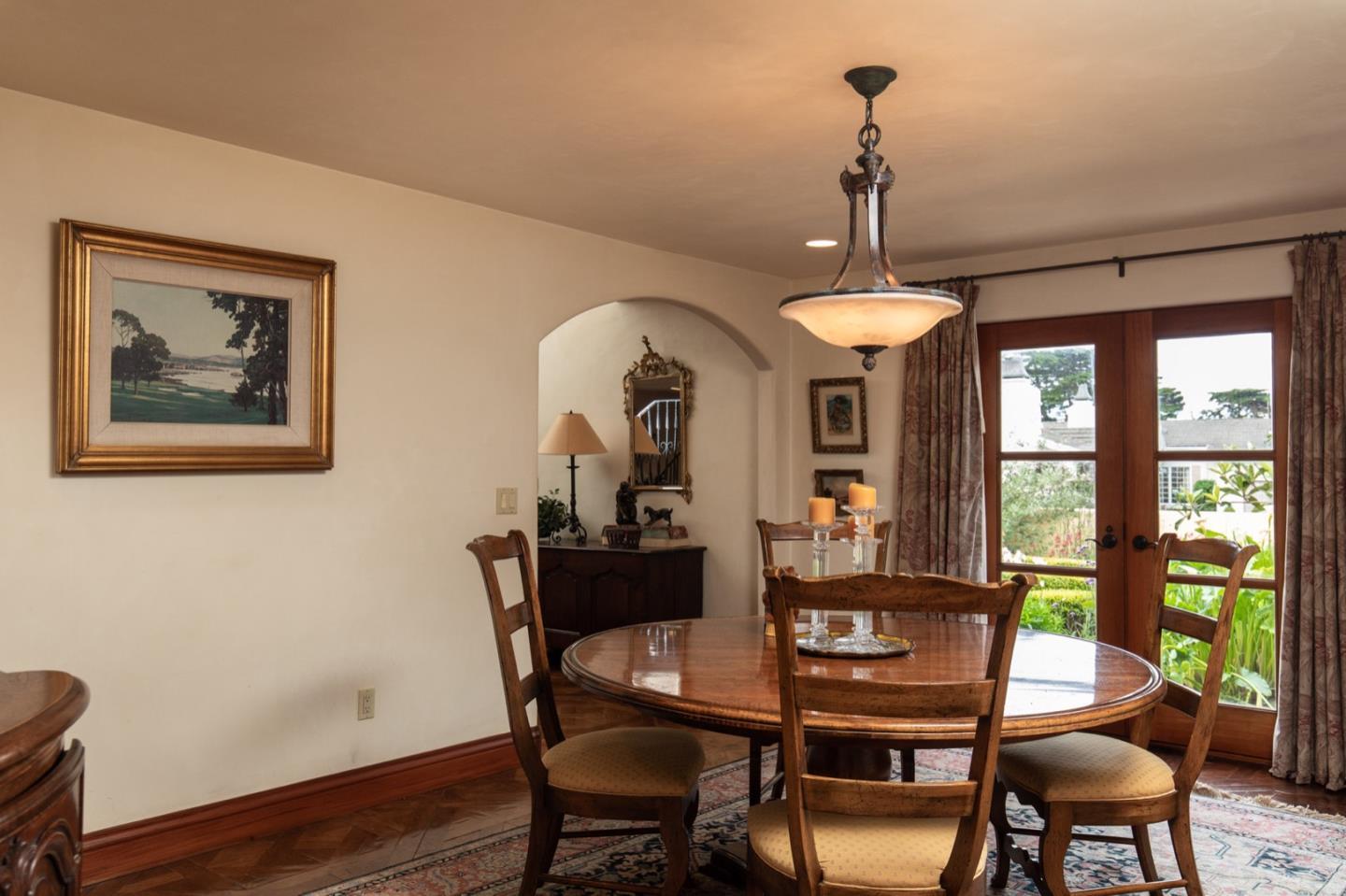 1007 Ocean Road Pebble Beach, CA 93953 - Photo 13 of 24 a dining room with furniture a chandelier and wooden floor