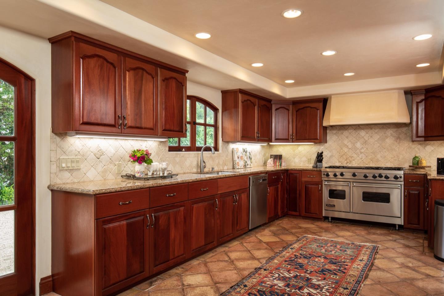 1007 Ocean Road Pebble Beach, CA 93953 - Photo 14 of 24 a kitchen with stainless steel appliances granite countertop a stove sink and cabinets