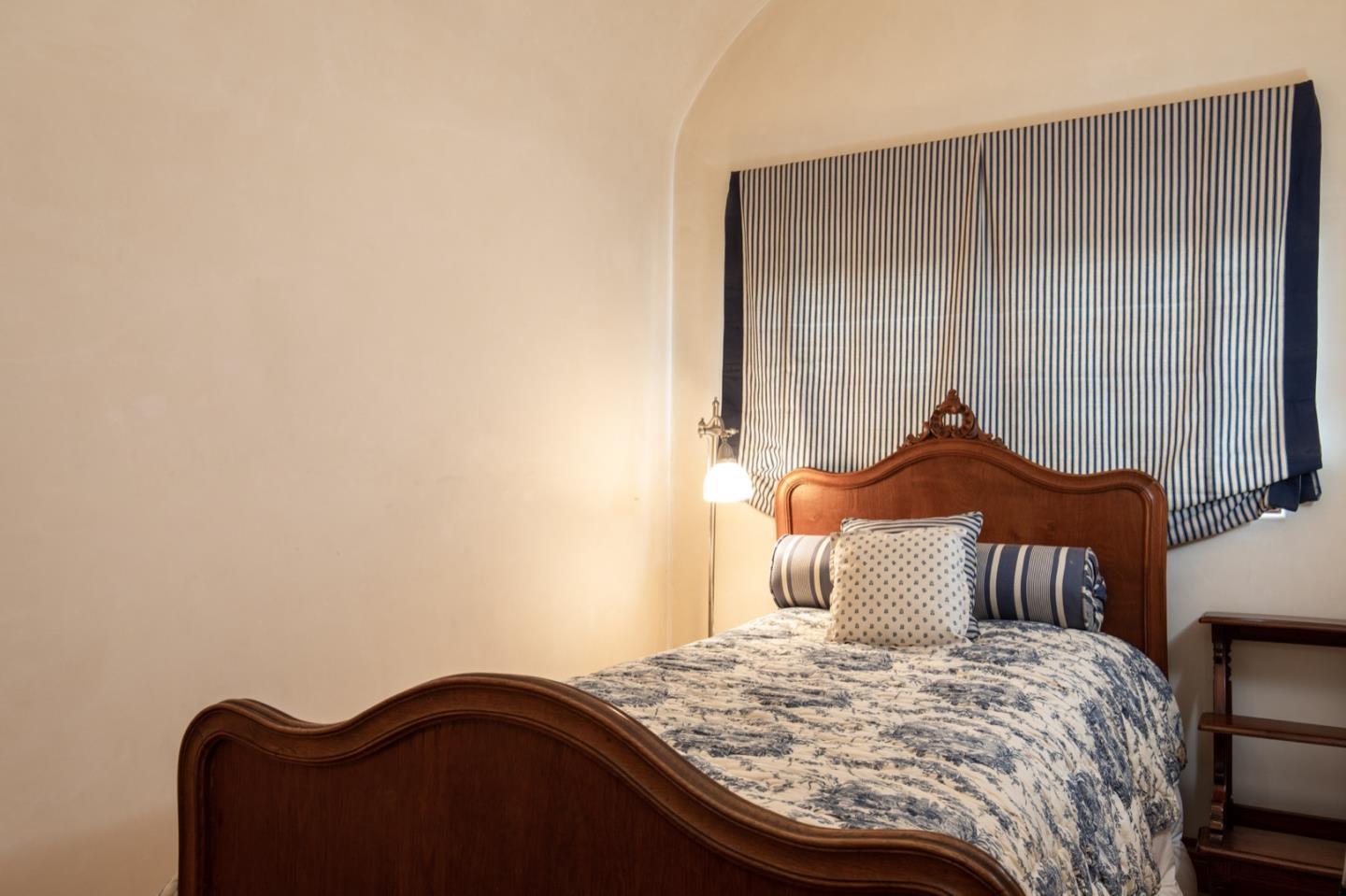 1007 Ocean Road Pebble Beach, CA 93953 - Photo 18 of 24 a bedroom with a bed and a dresser