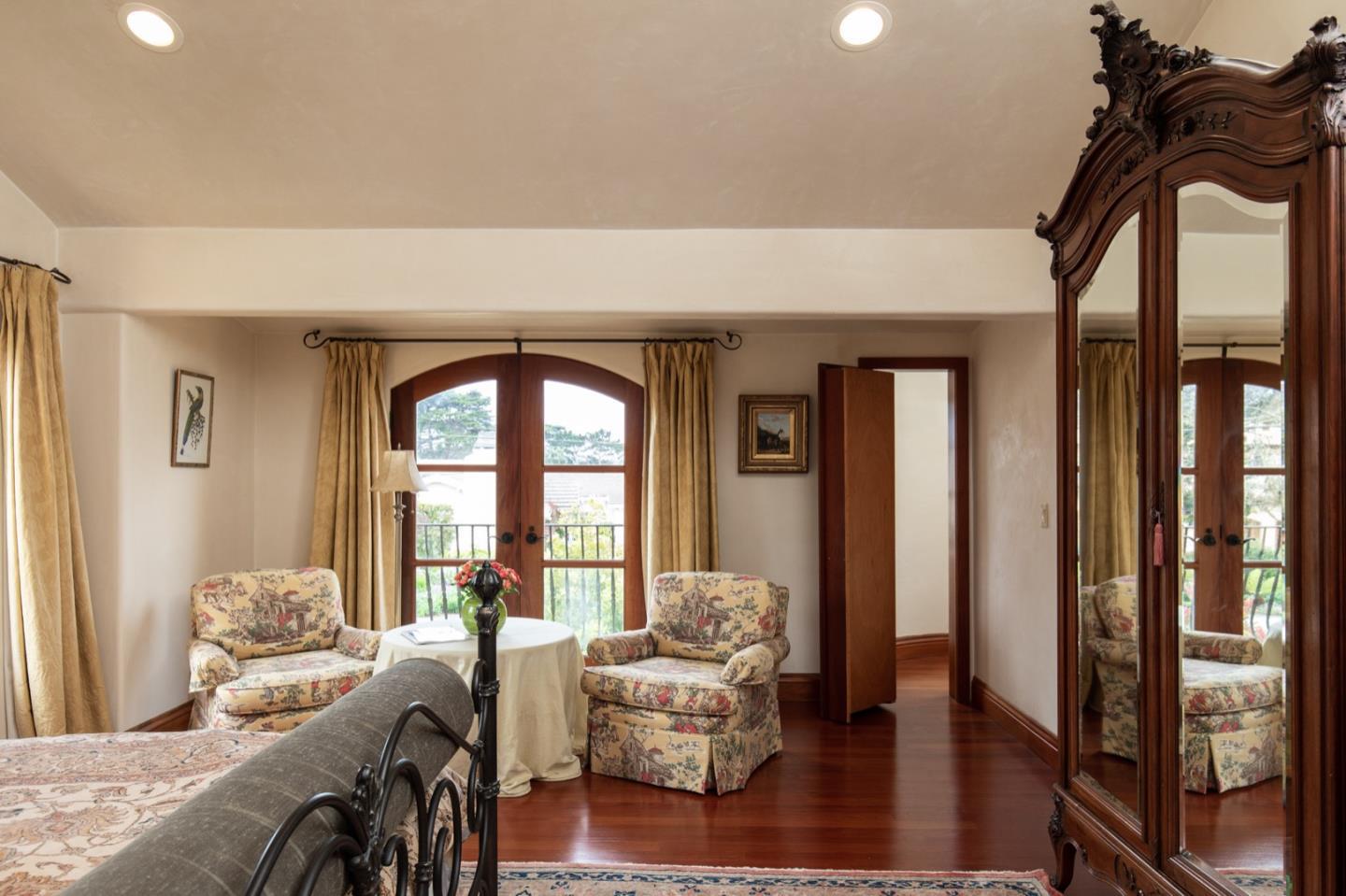 1007 Ocean Road Pebble Beach, CA 93953 - Photo 20 of 24 a living room with furniture and a large window