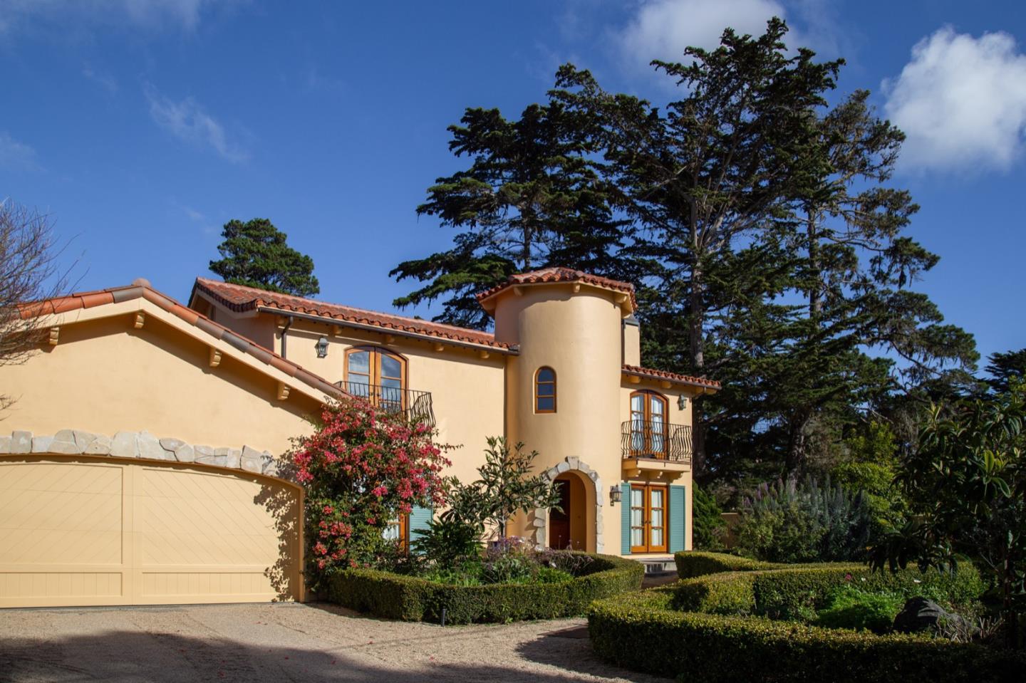 1007 Ocean Road Pebble Beach, CA 93953 - Photo 2 of 24 a front view of a house with a garden