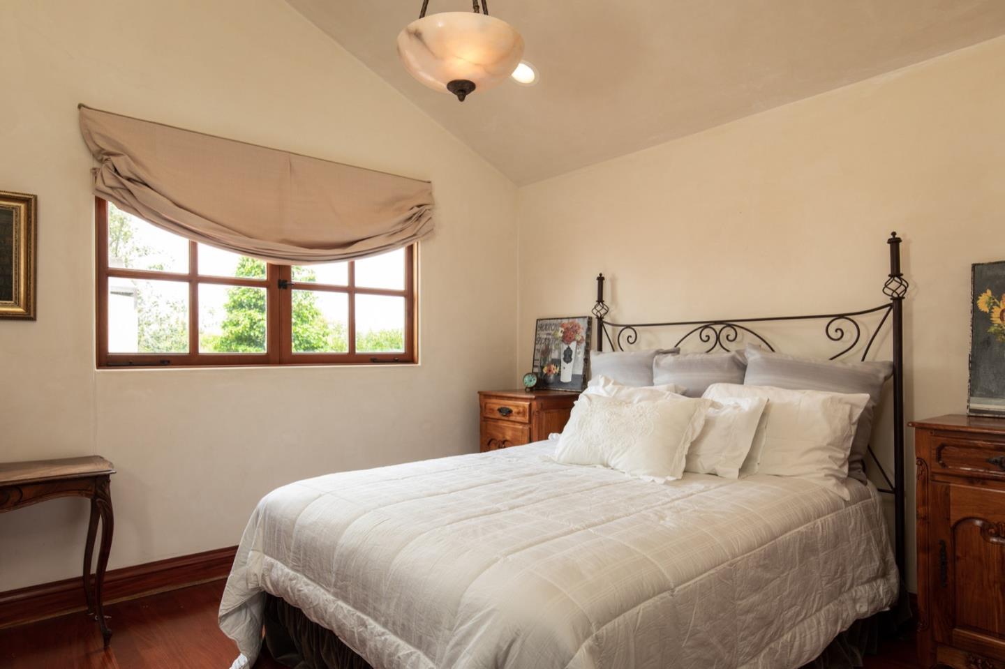 1007 Ocean Road Pebble Beach, CA 93953 - Photo 22 of 24 a bedroom with a bed and window