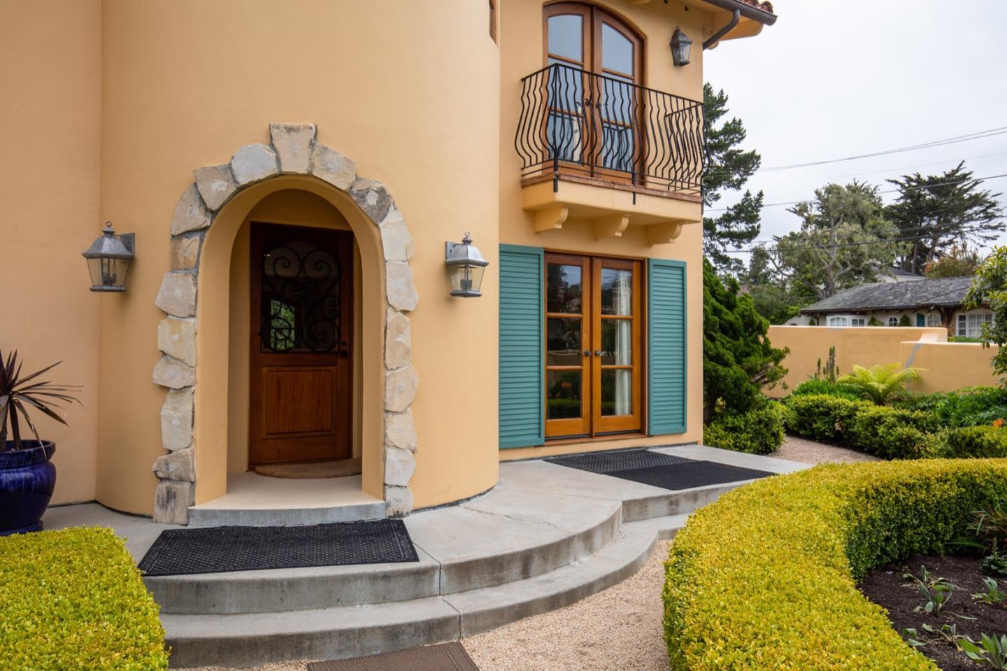1007 Ocean Road Pebble Beach, CA 93953 - Photo 8 of 24 a front view of a house with a yard