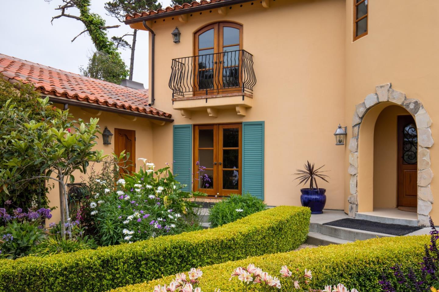 1007 Ocean Road Pebble Beach, CA 93953 - Photo 9 of 24 a front view of a house with a yard