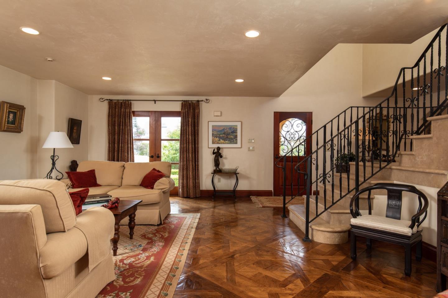 1007 Ocean Road Pebble Beach, CA 93953 - Photo 10 of 24 a living room with furniture or stairs and a window