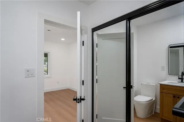 a bathroom with a granite countertop toilet and a sink