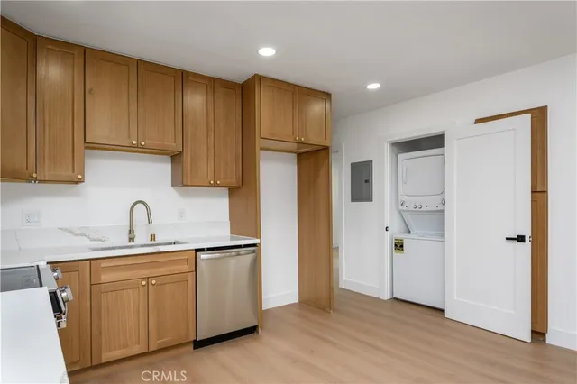 a kitchen with stainless steel appliances granite countertop a refrigerator sink and cabinets