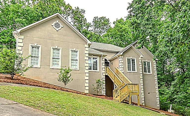 114 Due W Street Dallas, GA 30157 - Photo 1 of 32 a front view of a house with a yard and potted plants