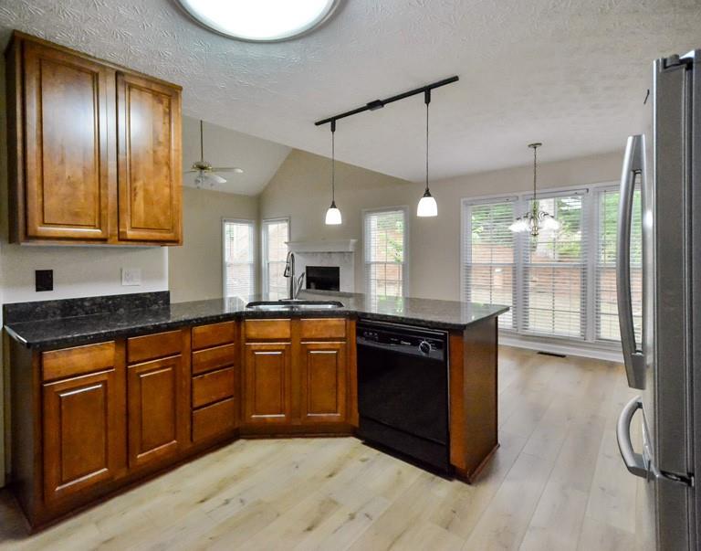 114 Due W Street Dallas, GA 30157 - Photo 10 of 32 a kitchen with stainless steel appliances granite countertop a stove a sink dishwasher and a refrigerator with wooden floor