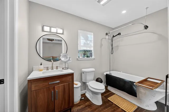 a spacious bathroom with a toilet sink and mirror