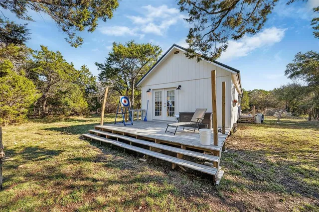 a view of a house with backyard porch and sitting area