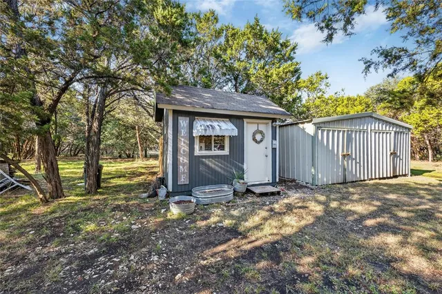 a view of a house with a yard and tree
