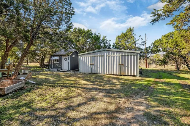 a view of a house with backyard and sitting area