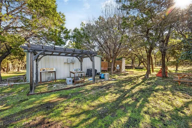 a view of a house with backyard and sitting area