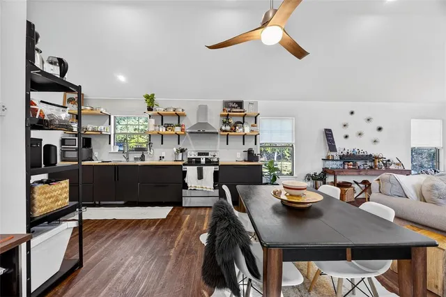 a living room with lots of furniture and kitchen view