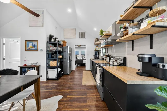 a kitchen with stainless steel appliances granite countertop a stove and a refrigerator