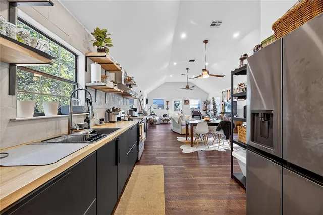 a kitchen with stainless steel appliances granite countertop lots of counter top space and furniture