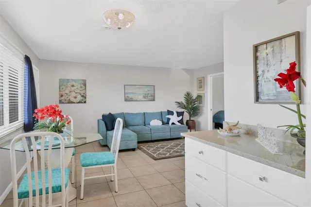 a living room with furniture and flowers