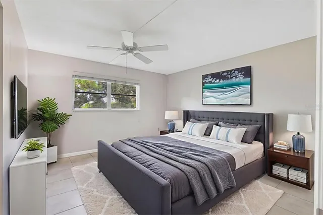 a bedroom with bed and paintings on the wall