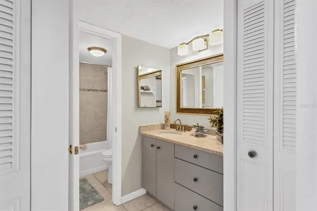 a bathroom with a sink a mirror and a shower