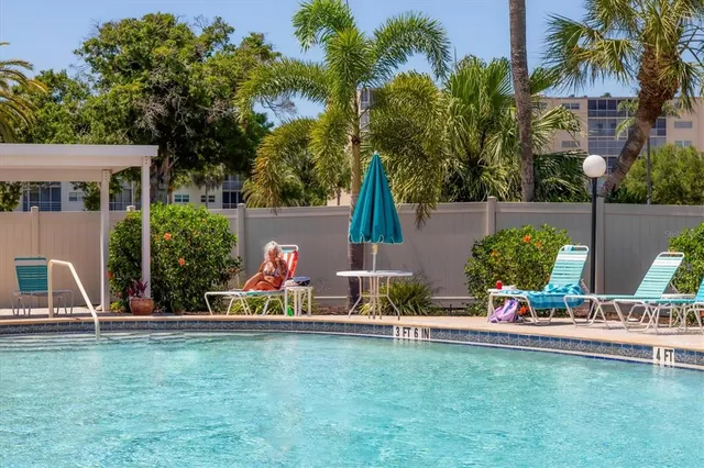 front view of house with a garden and swimming pool