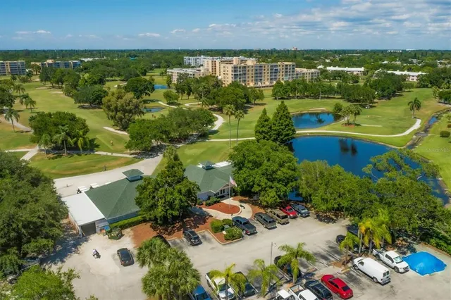an aerial view of ocean with residential houses with outdoor space and trees