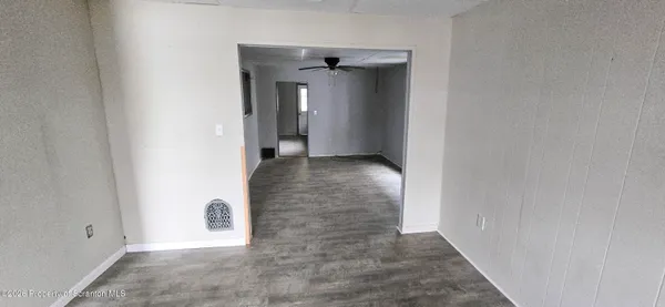 an empty room with windows and closet